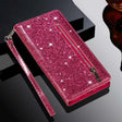 Sparkly pink wallet-style phone case with a zipper pocket and wrist strap.