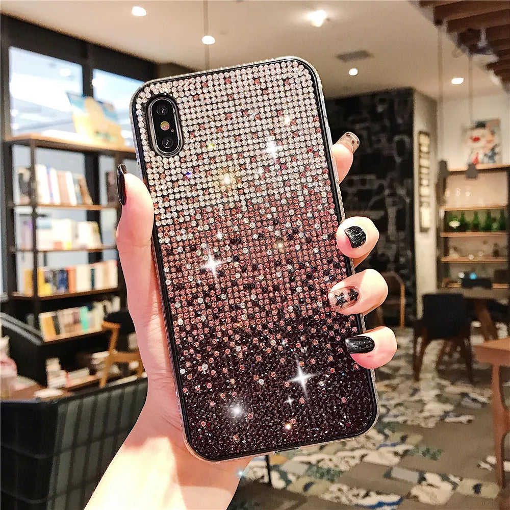 Sparkly, rhinestone-encrusted smartphone case with a gradient from silver to dark purple.