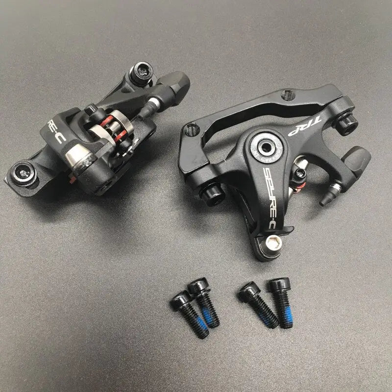 two black and white brake levers on a gray surface