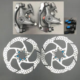 two brake disc brakes with blue brake pads
