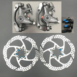 two disc brakes with blue brake pads
