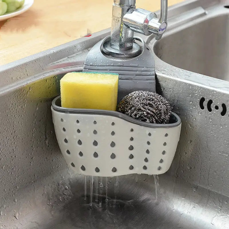 a sink with a soap brush and sponge in it