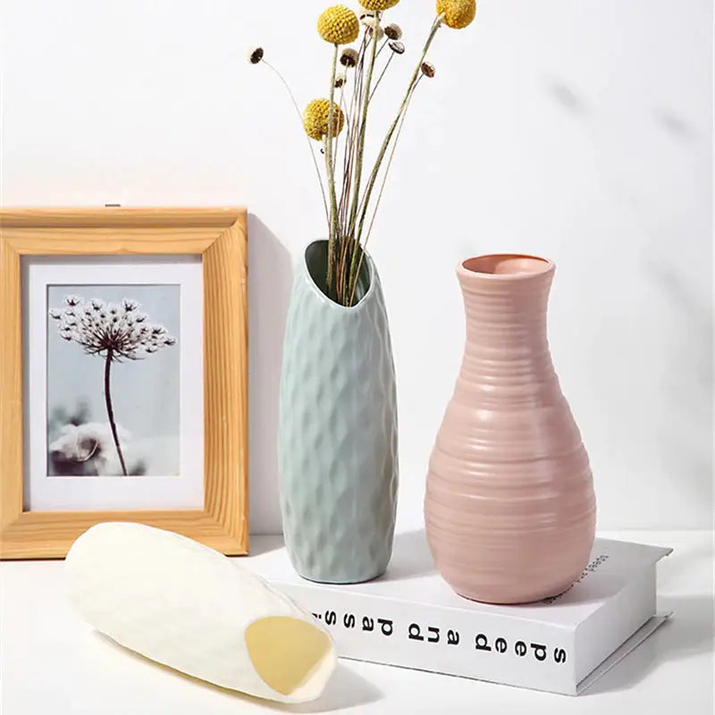 a vase with flowers in it and a picture frame