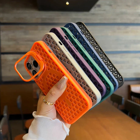 Stack of colorful perforated phone cases held in a hand.