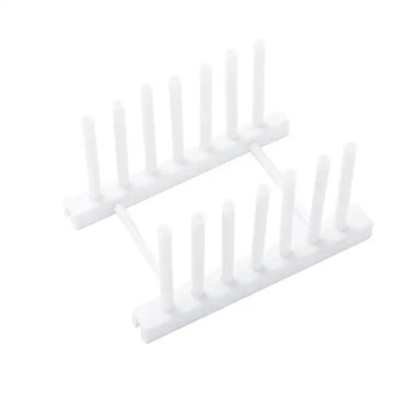 a white plastic rack with four white plastic pegs