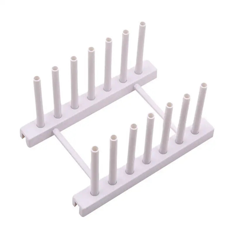 a white plastic rack with six white plastic tubes
