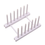 a white plastic rack with six white plastic tubes
