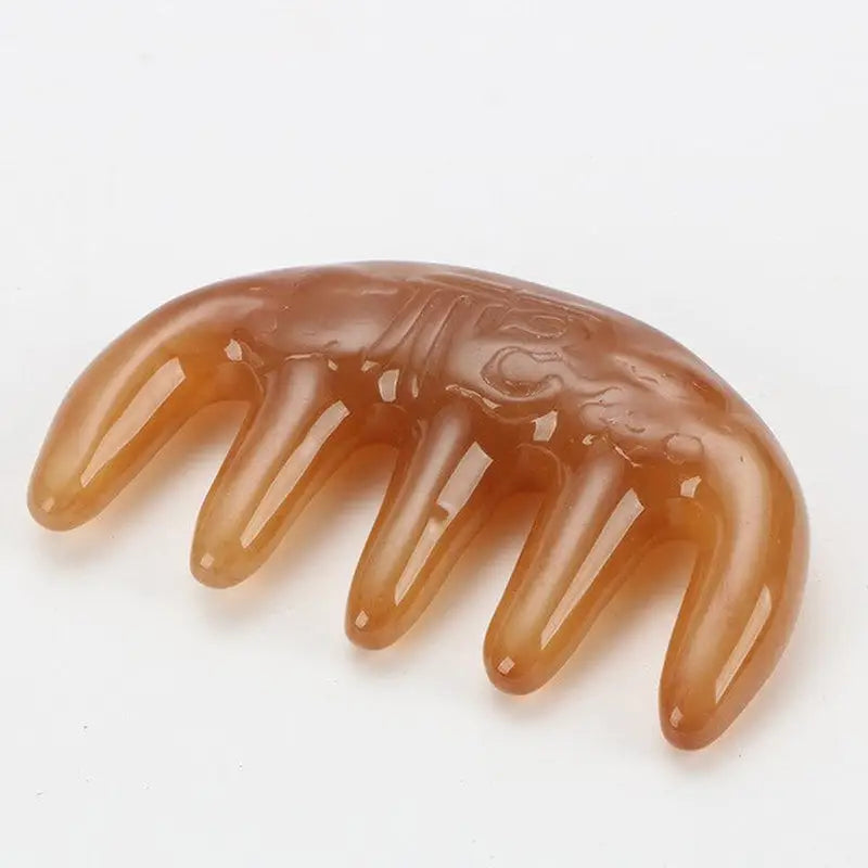 a piece of brown colored plastic hair comb