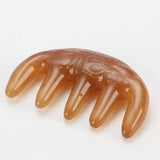 a piece of brown colored plastic hair comb