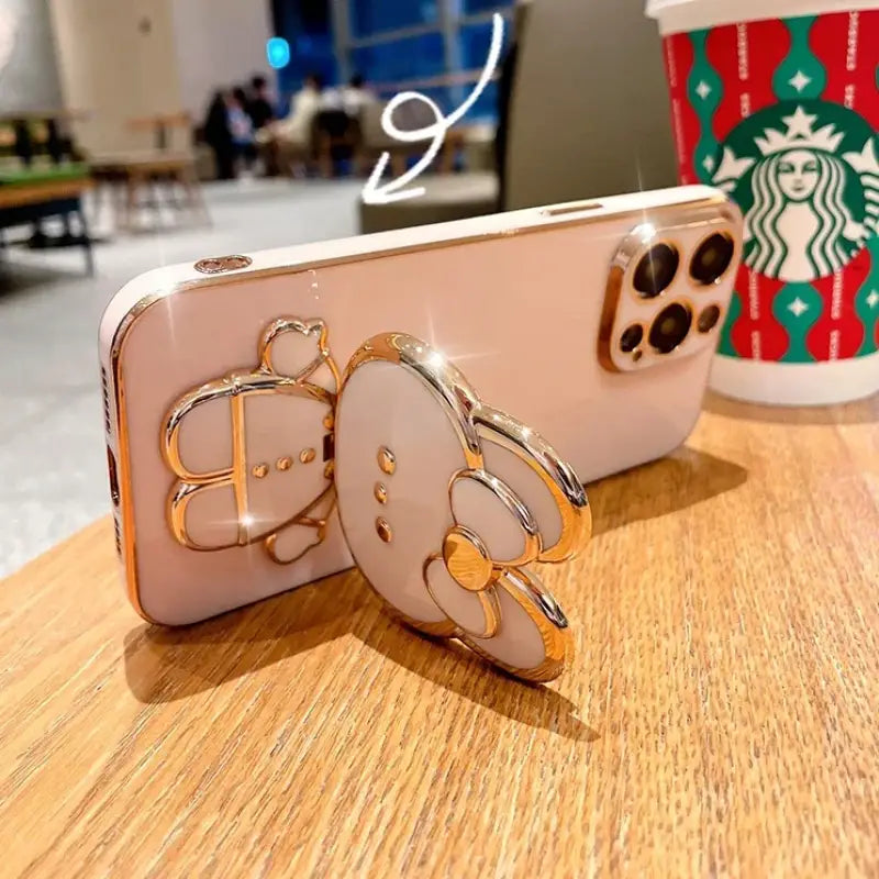 a starbucks cup and a phone on a table