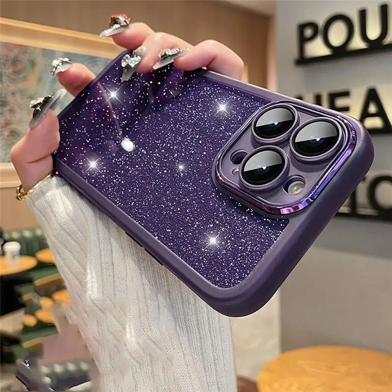 a woman holding a purple glitter phone case