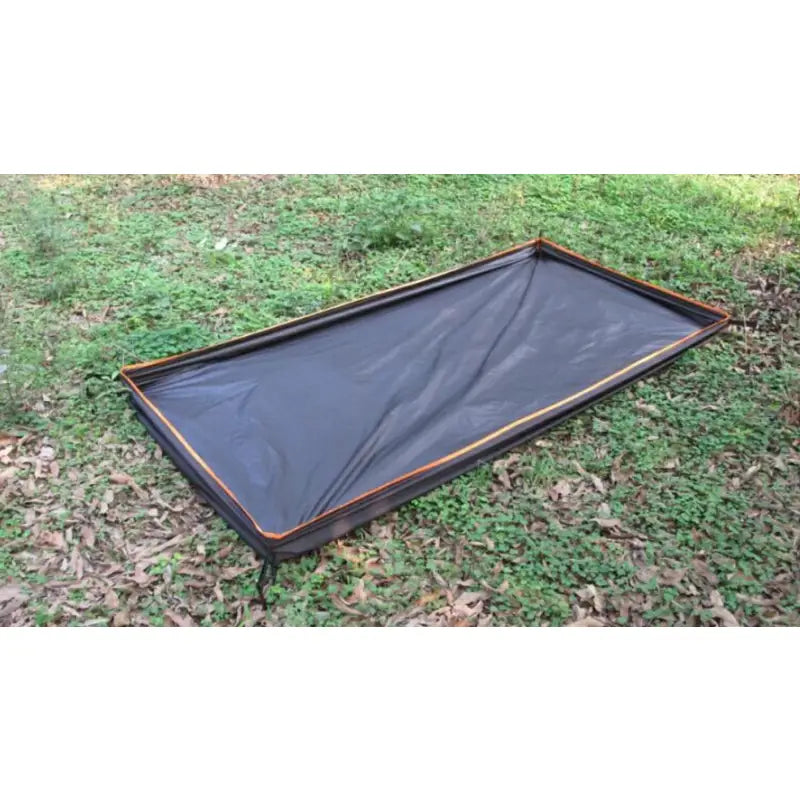 a black tarp on the ground with a black tarp covering it