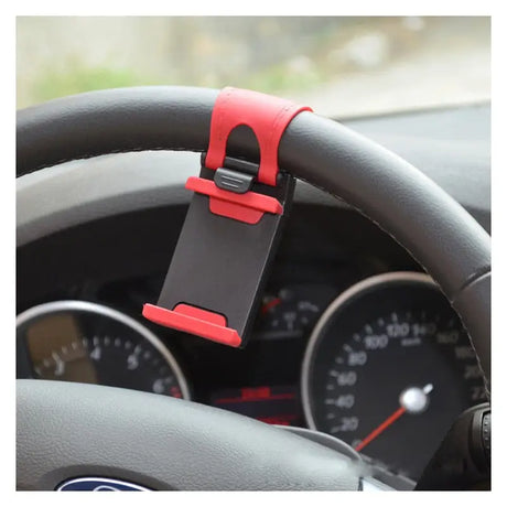 a close up of a steering wheel with a cell phone attached to it