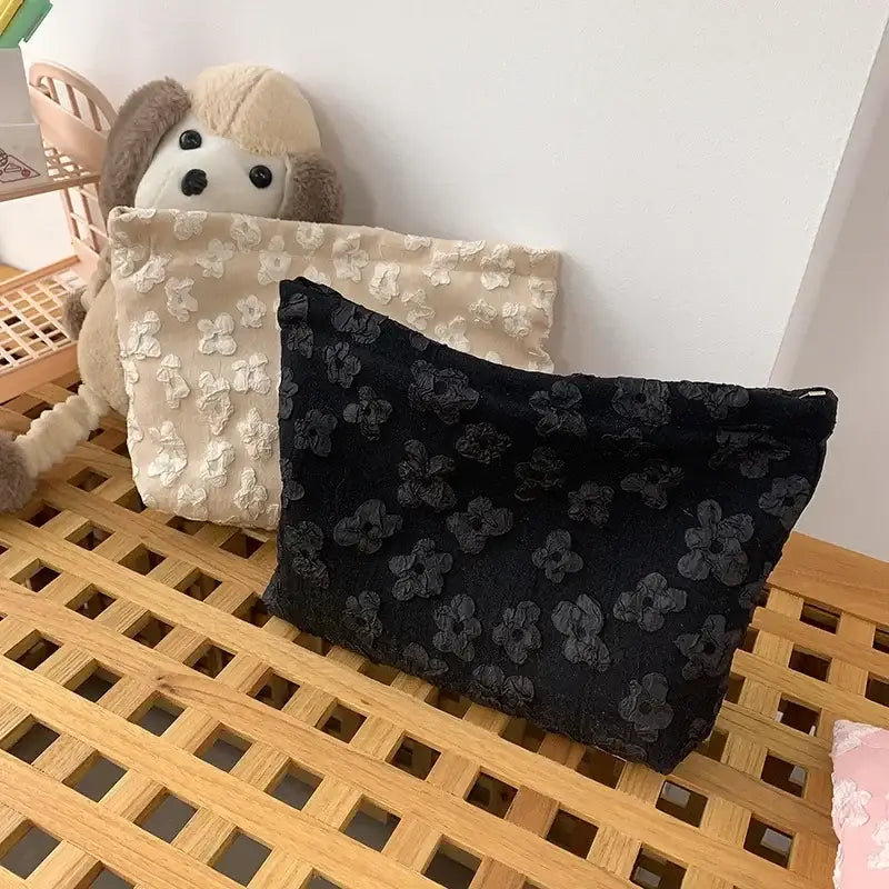 a stuffed animal sitting next to a black bag