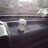 a stuffed animal sitting in the passenger seat of a car