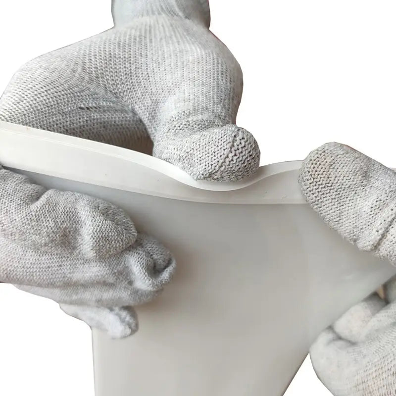 a pair of gloves on a toilet