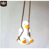 a stuffed penguin hanging on a wall