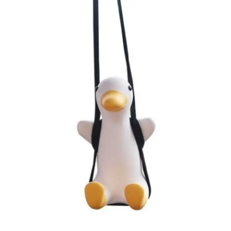 a stuffed penguin hanging on a white background