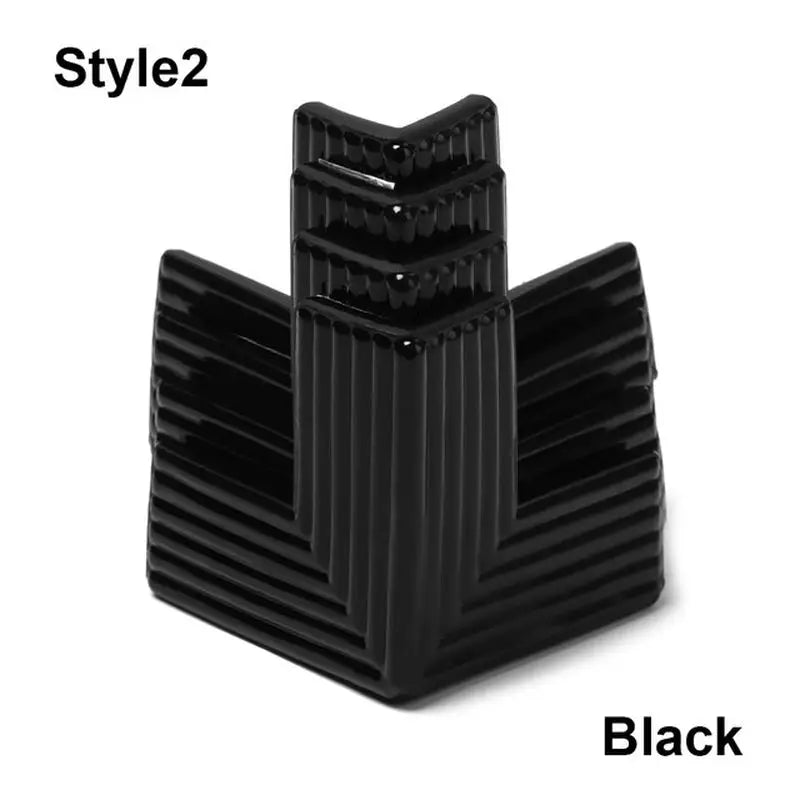 a black plastic cup holder with a white background