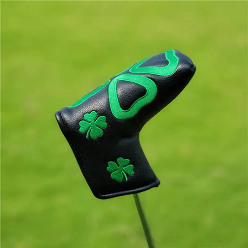a golf putter’s glove with a green shamrock on it