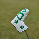 a close up of a golf putter cover with a shamrock design