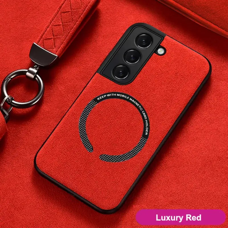 a close up of a red phone case with a keychain