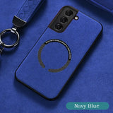 a close up of a cell phone case with a keychain on a blue surface