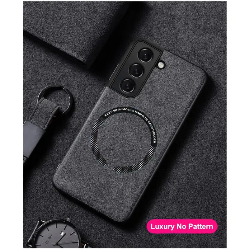 the back of a black phone case with a circular design