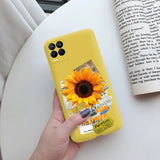 a person holding a yellow phone case with a sunflower on it