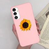 a woman holding a pink phone case with a sunflower on it
