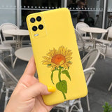 a hand holding a yellow phone case with a sunflower on it