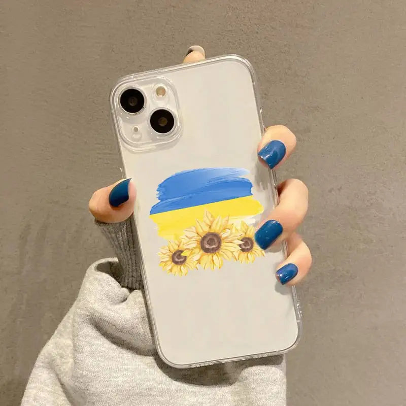 a woman holding a phone case with a sunflower painted on it