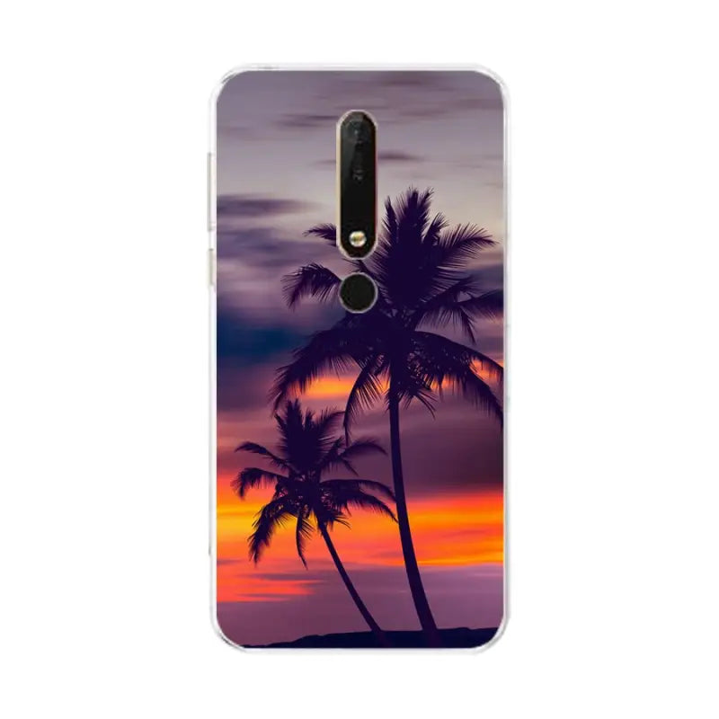 a sunset with palm trees on the beach phone case