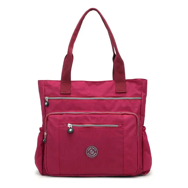 a pink handbag with zippers and zippers