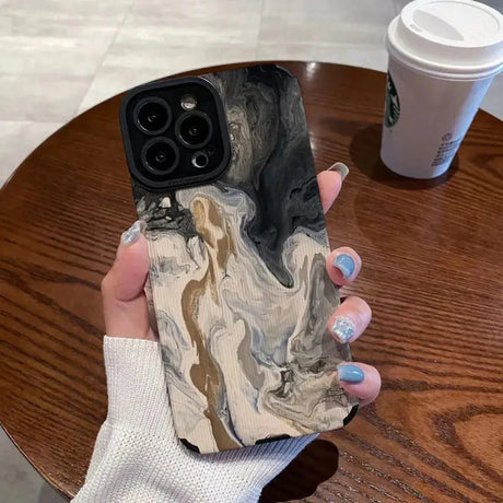 a woman holding a phone case with a marble pattern