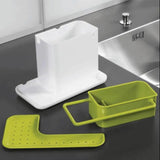 a close up of a sink with a green holder and a sink