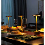 a table with a plate of food and wine glasses