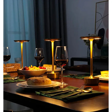 A table with a plate of food and wine glasses