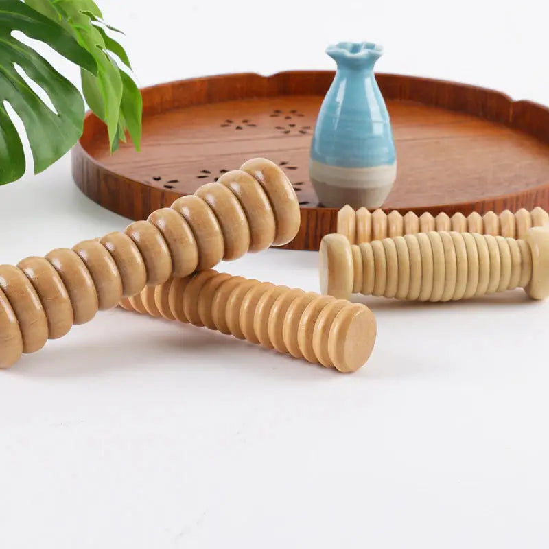 there are three wooden dows on a tray next to a vase