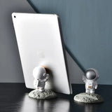 a tablet and a small robot on a desk