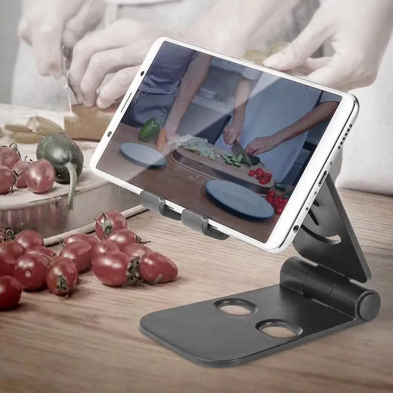 a tablet with a tablet on it and a person cutting vegetables