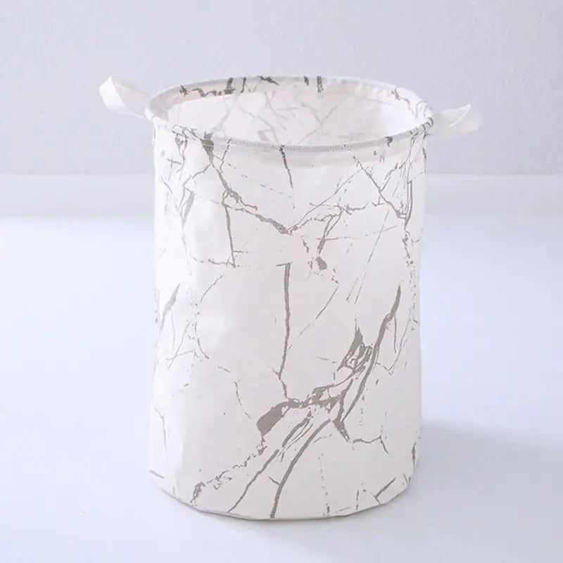 a white and black marble bucket with handles