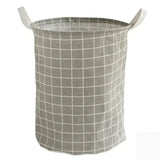 a grey and white basket with a white grid pattern