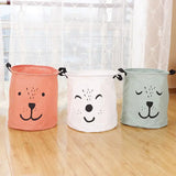 three colorful dog shaped storage baskets on a wooden floor
