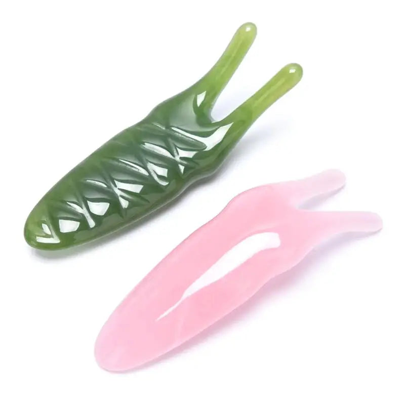 two green and pink plastic teeth