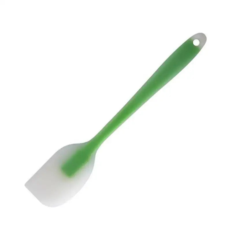 a green and white spat with a white handle