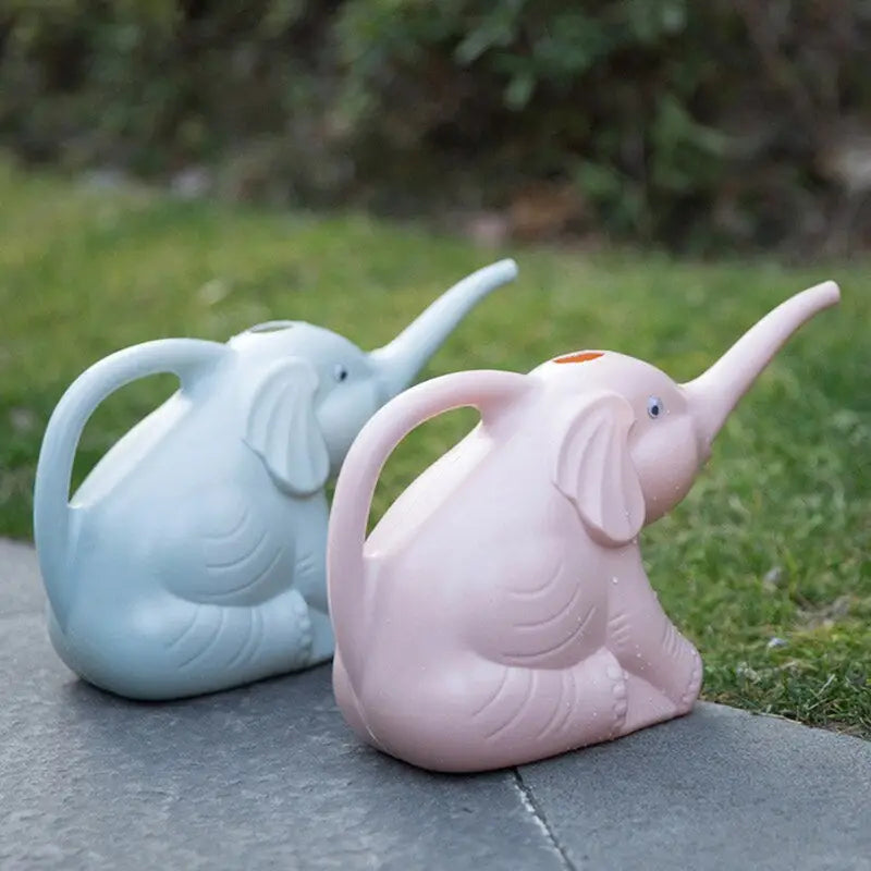 two small elephants sitting on the ground