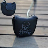 a black purse with a skull and crossbone on it