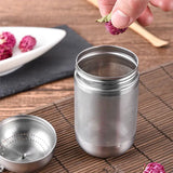 a person is placing a flower into a metal strainer