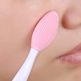 a woman brushing her teeth with a tooth brush